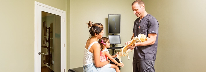 Chiropractor Westchase FL Andrew Danks With Pediatric Patient